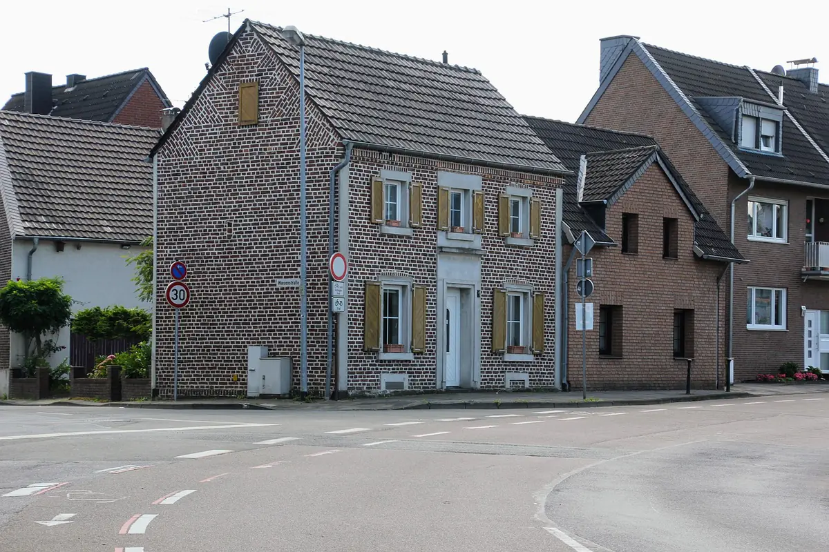 Residential street with two-storey brick houses and tiled roofs