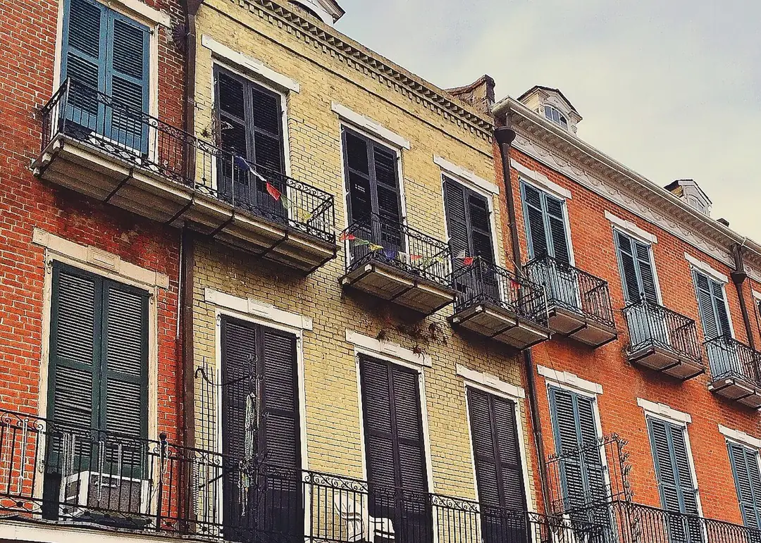 Multi-storey period buildings with shutters, balconies and wrought-iron railings